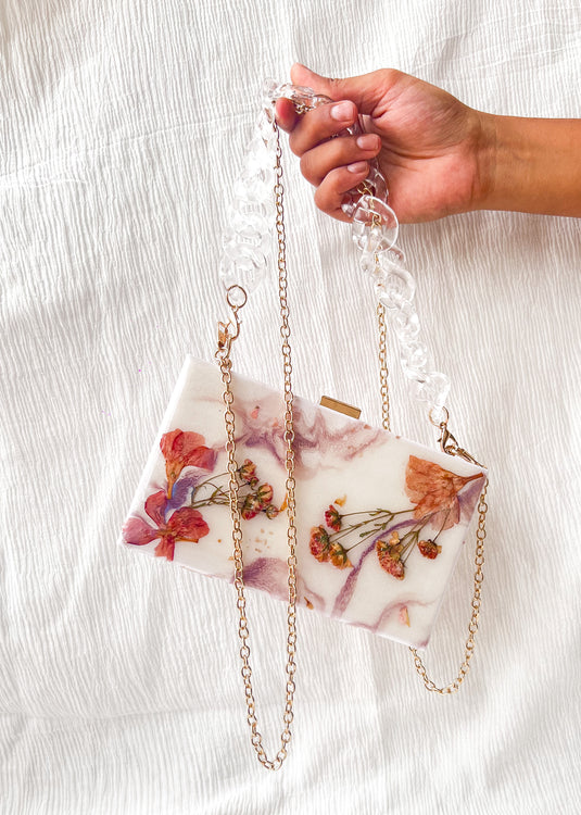 Resin clutch with real dried flowers with abstract effect on the top